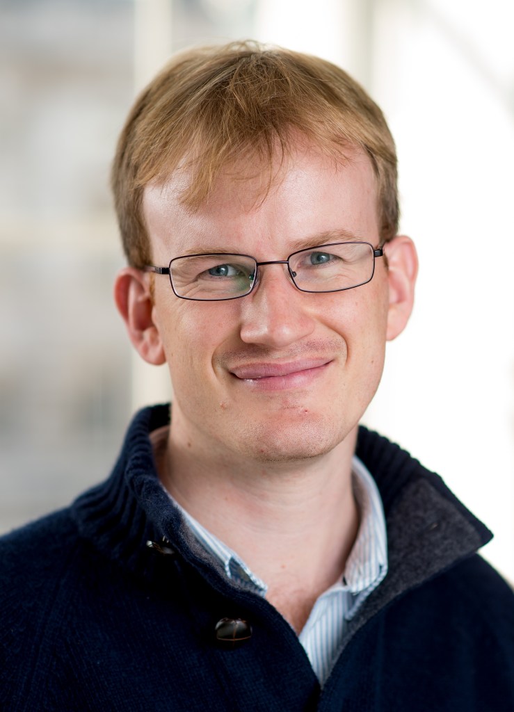A headshot of James Grande.